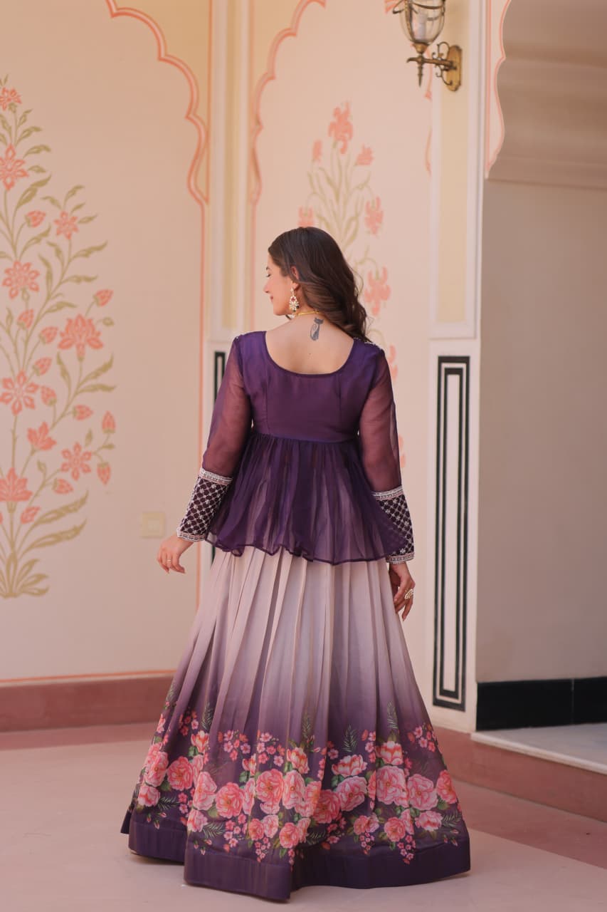 Woman wearing a purple and floral dress in an ornate room.