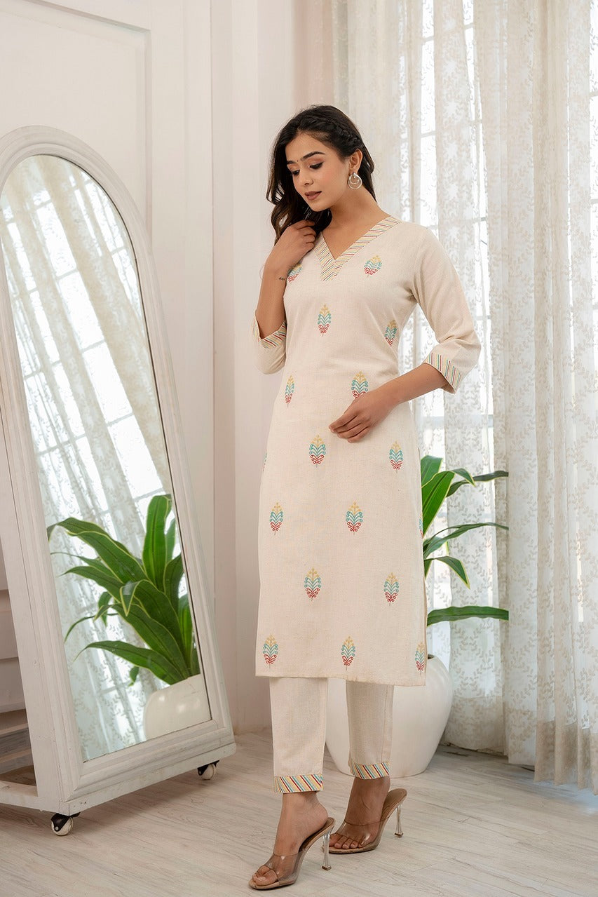 Cream cotton flex kurta pant set for women with V-neck embroidery, perfect for workwear and casual outings