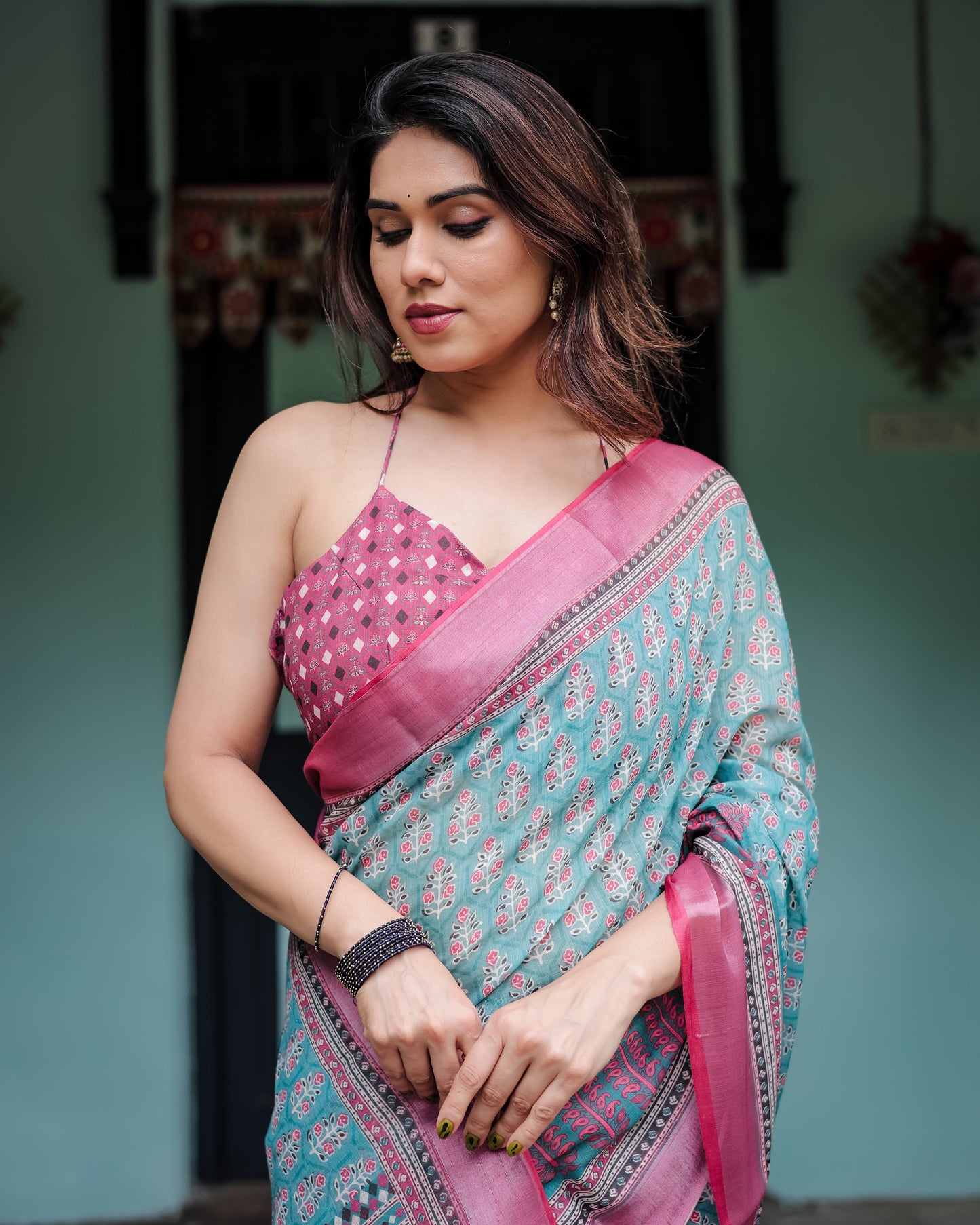 Aqua Blue Pure Cotton Linen Saree with Pink Border, Floral Motifs, and Tassel Detailing