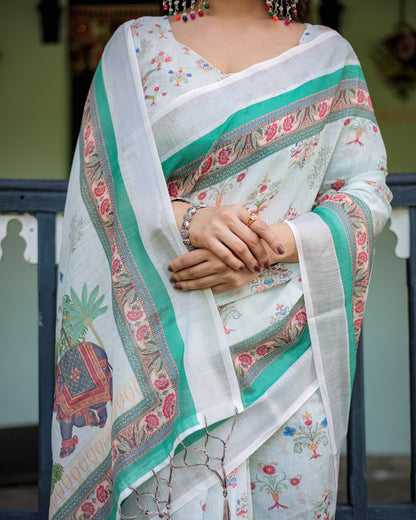 Ivory Pure Cotton Linen Saree with Elephant Motif and Floral Pattern, Green and Pink Borders, and Tassels on Edges.