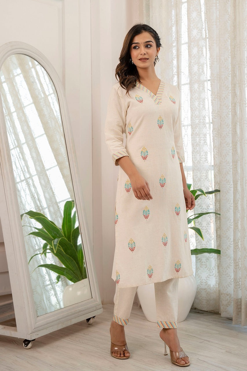 Cream cotton flex kurta pant set for women with V-neck embroidery, perfect for workwear and casual outings