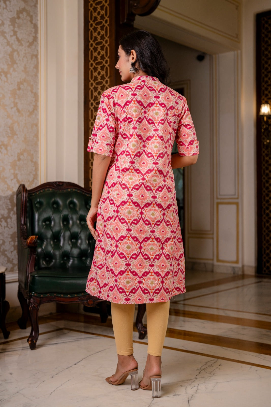 Traditional print cotton flex kurti in pink multicolor with stand collar, trendy sleeves, side slits, and functional pockets.