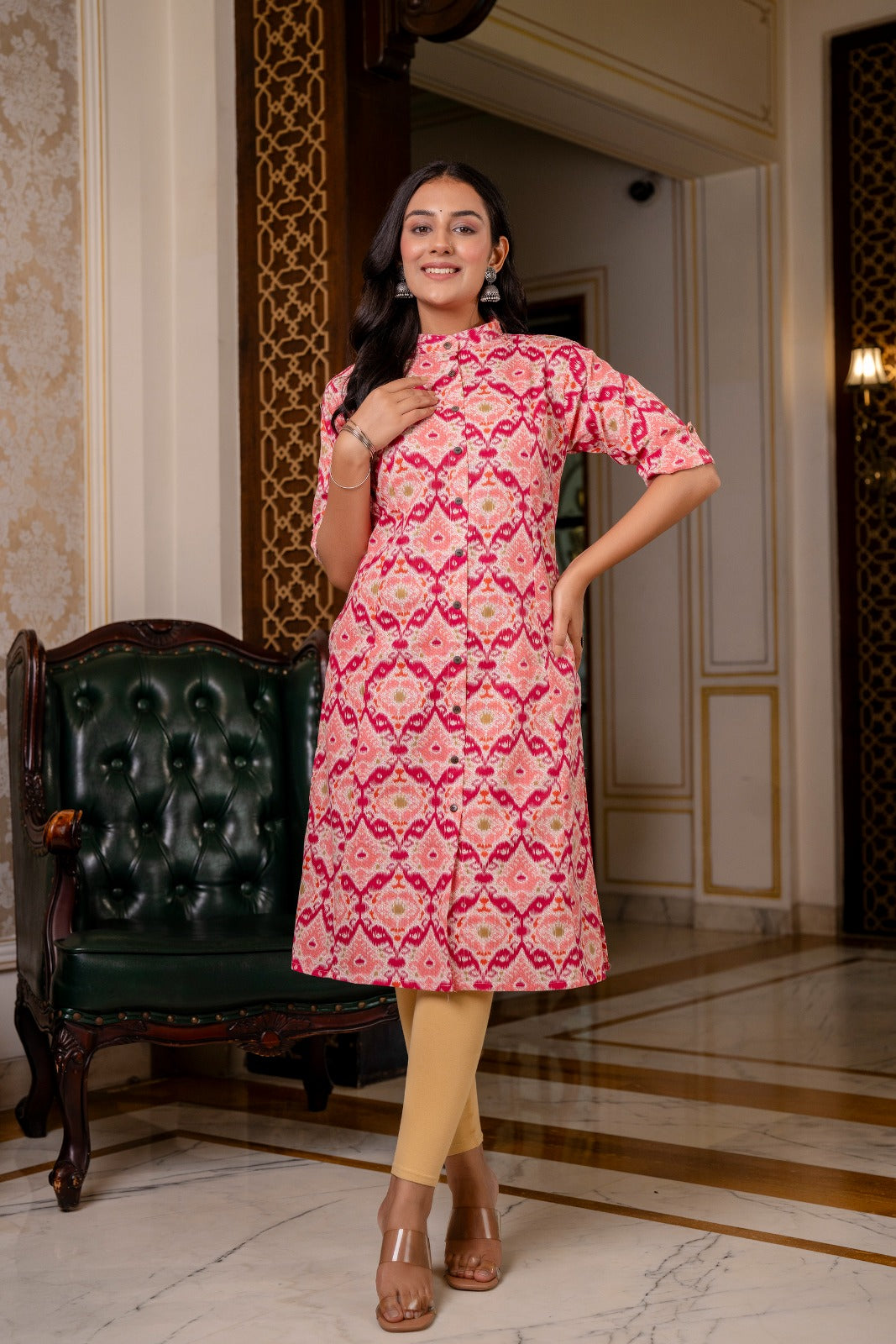 Traditional print cotton flex kurti in pink multicolor with stand collar, trendy sleeves, side slits, and functional pockets.