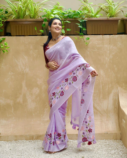 Soft linen saree with silver woven border and thread embroidery.