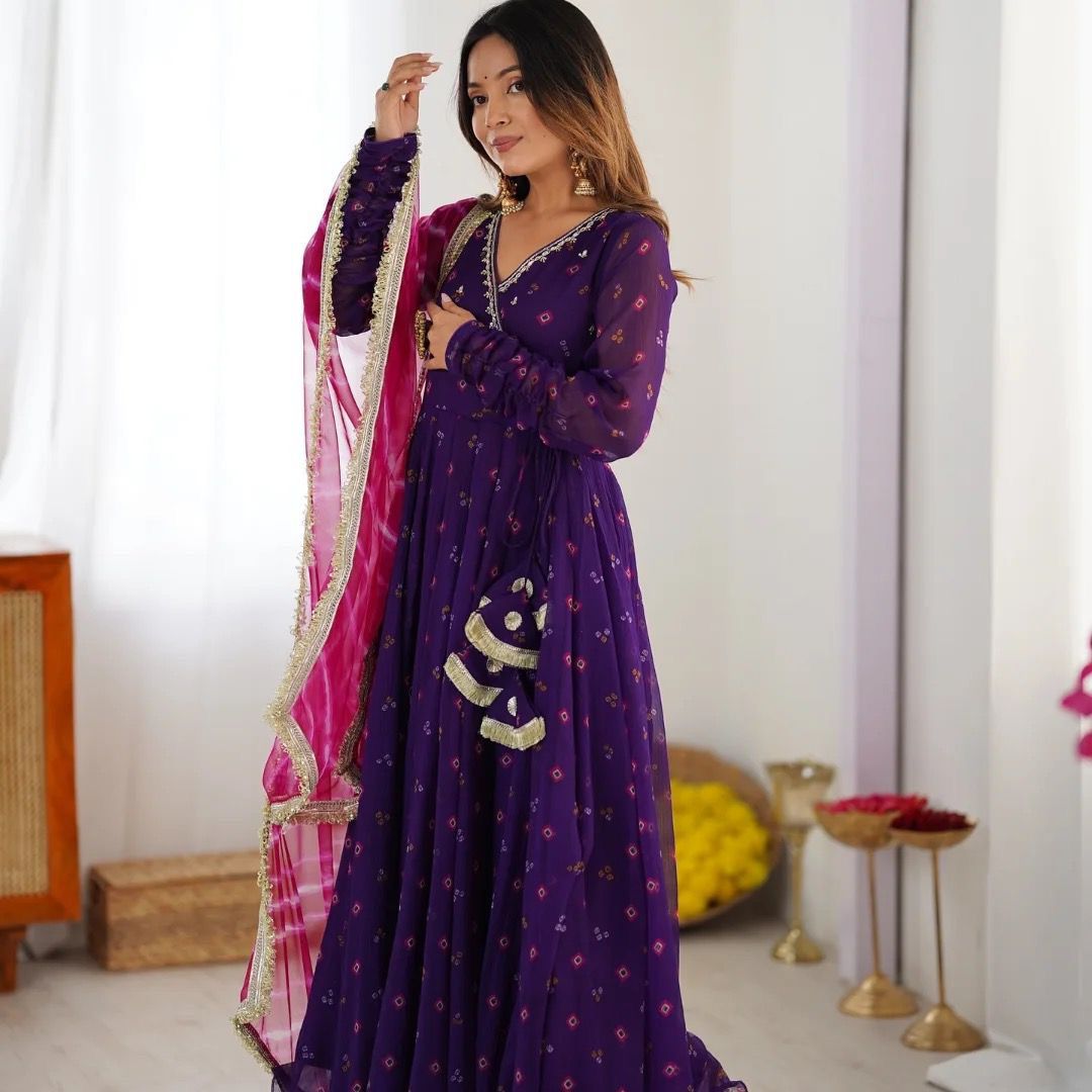 Designer Anarkali gown set with embroidered neckline, faux georgette fabric, matching pants, and printed dupatta – festive wear