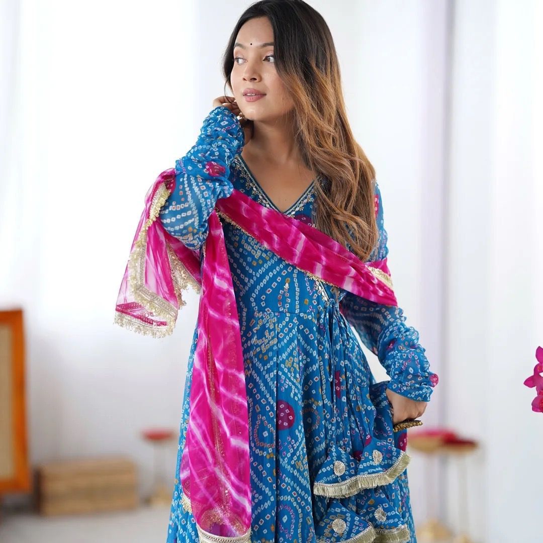 Designer Anarkali gown set with embroidered neckline, faux georgette fabric, matching pants, and printed dupatta – festive wear